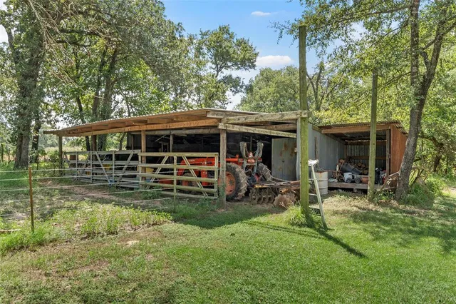 a view of a patio with table and chairs under an umbrella