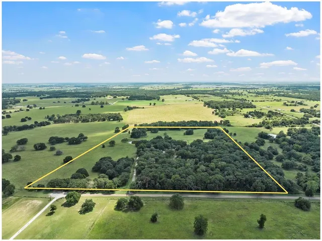 a view of a house with backyard sitting area and garden