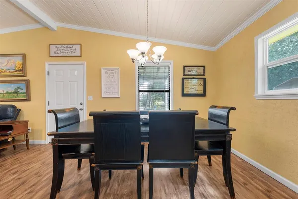 a view of a dining room with furniture and window