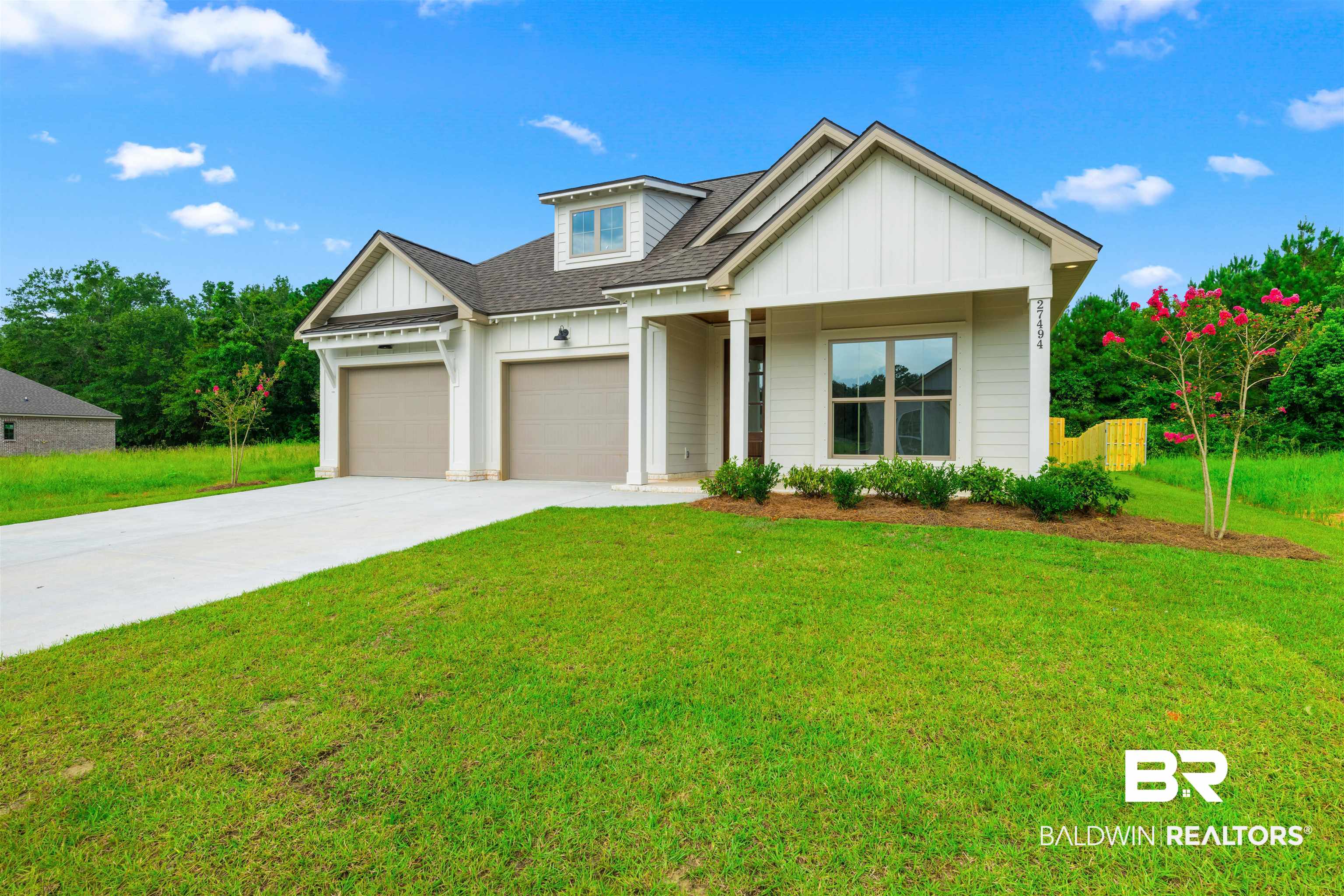 27494 Patch Pl Loop Daphne, AL 36526 - Photo 2 of 26 Modern farmhouse exterior with white board and batten siding, a prominent dormer, and a covered entry