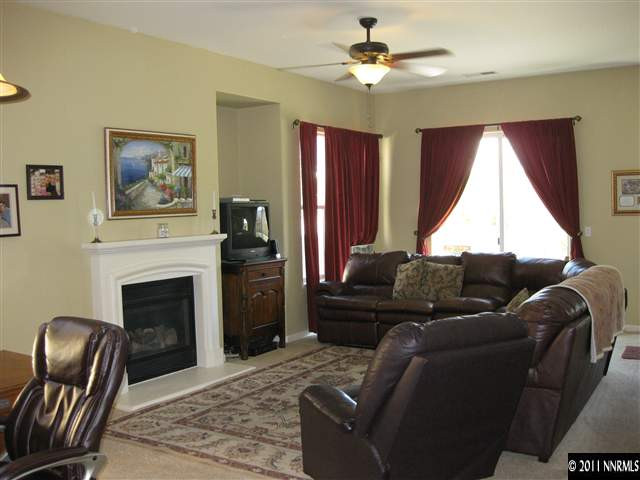 1610 Caliterra Way Reno, NV 89521 - Photo 3 of 13 a living room with furniture a window and a fireplace