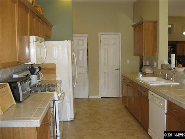 1610 Caliterra Way Reno, NV 89521 - Photo 5 of 13 a bathroom with a granite countertop sink a mirror and shower