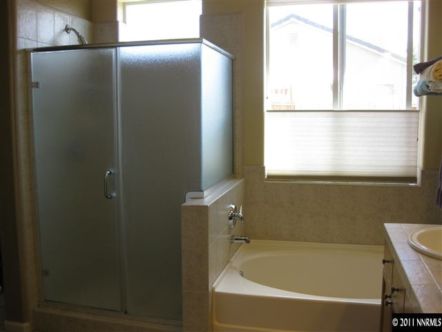 1610 Caliterra Way Reno, NV 89521 - Photo 9 of 13 a bathroom with a bathtub and a shower