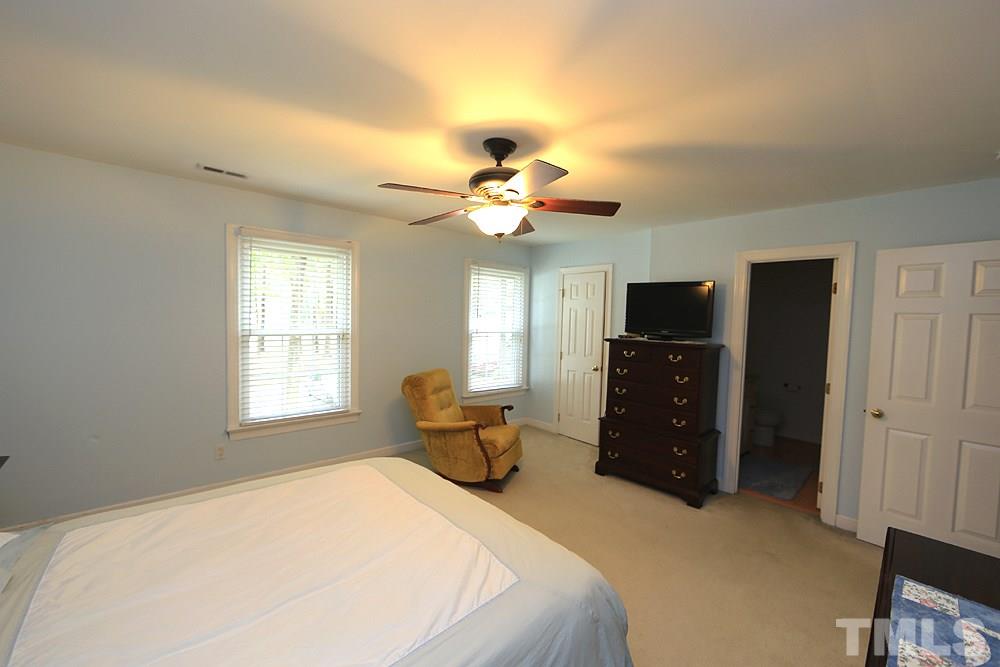 608 Weathergreen Drive Raleigh, NC 27615 - Photo 15 of 25 a bedroom with a bed dresser and a window