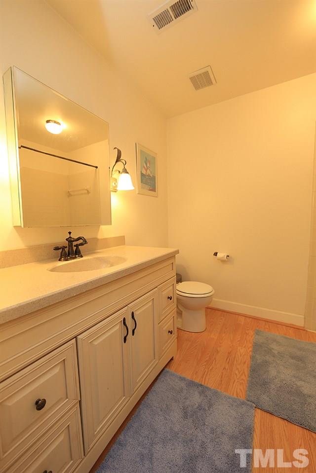 608 Weathergreen Drive Raleigh, NC 27615 - Photo 16 of 25 a spacious bathroom with a granite countertop sink a toilet and a mirror
