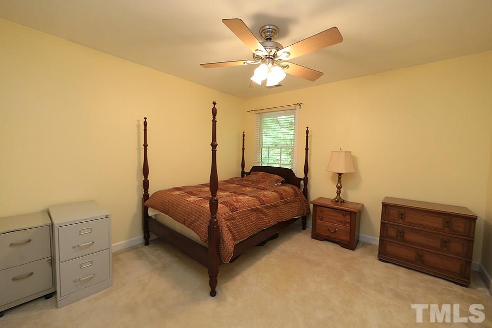 608 Weathergreen Drive Raleigh, NC 27615 - Photo 19 of 25 a bedroom with a bed and dresser