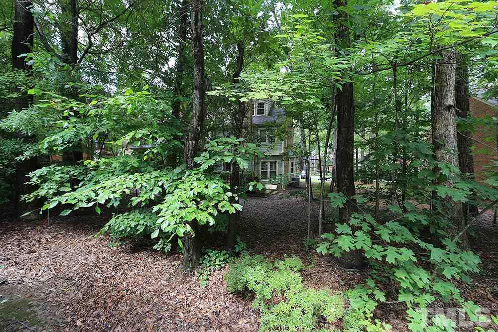 608 Weathergreen Drive Raleigh, NC 27615 - Photo 23 of 25 a view of a garden with large trees