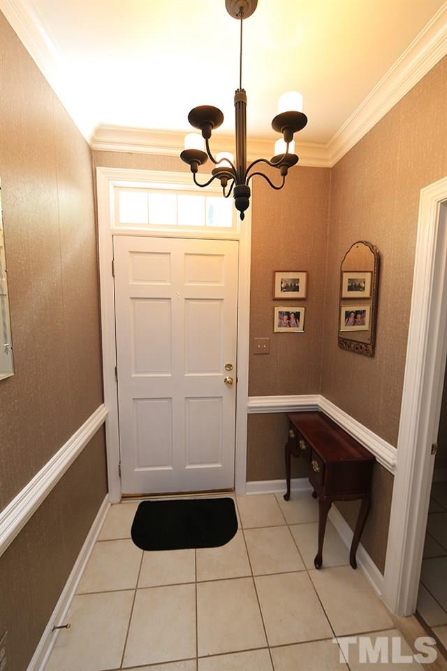 608 Weathergreen Drive Raleigh, NC 27615 - Photo 4 of 25 a room with a walk in closet and wooden floor