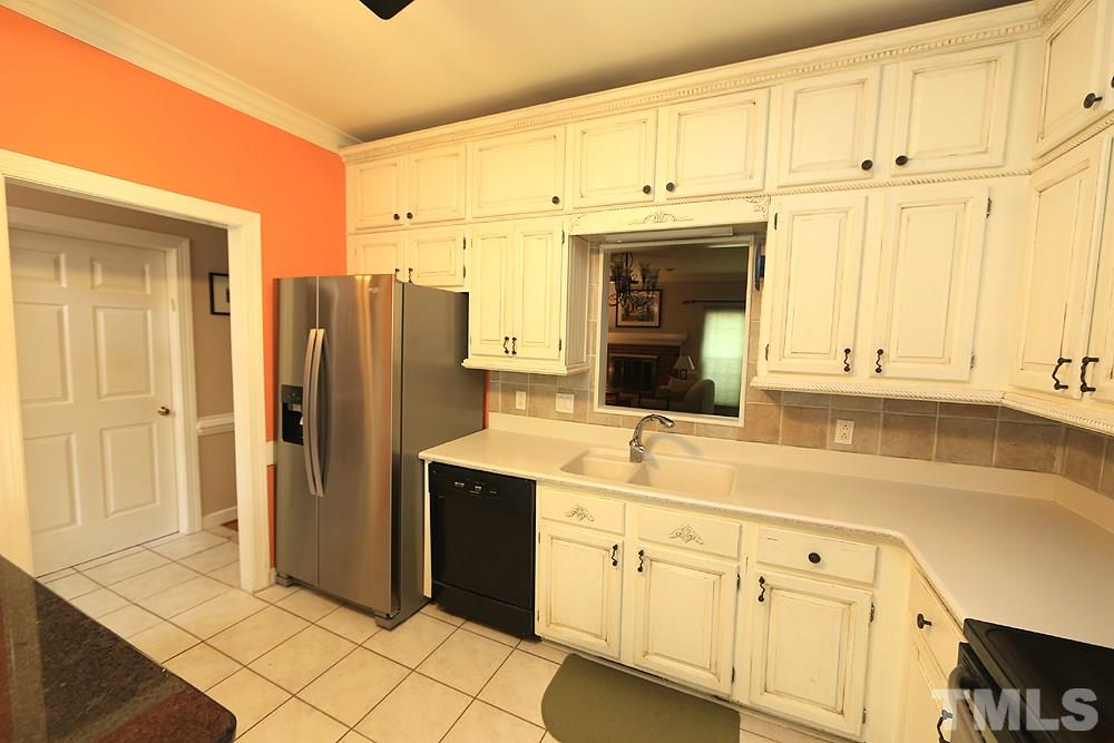 608 Weathergreen Drive Raleigh, NC 27615 - Photo 6 of 25 a kitchen with stainless steel appliances white cabinets and a window