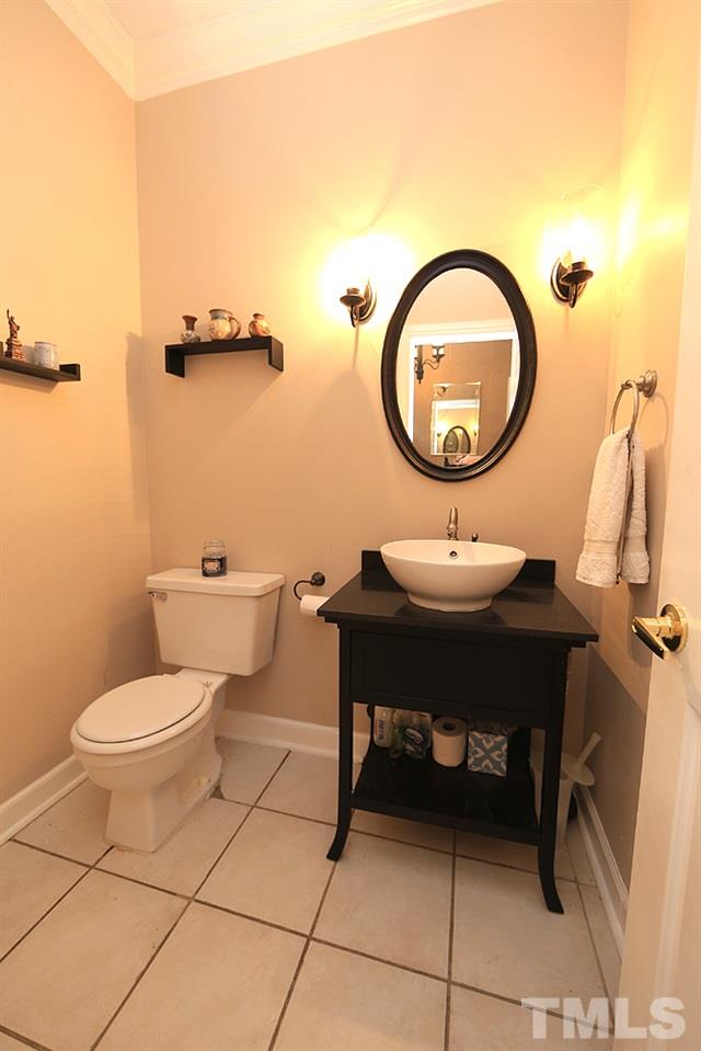 608 Weathergreen Drive Raleigh, NC 27615 - Photo 8 of 25 a bathroom with a toilet a sink and a mirror