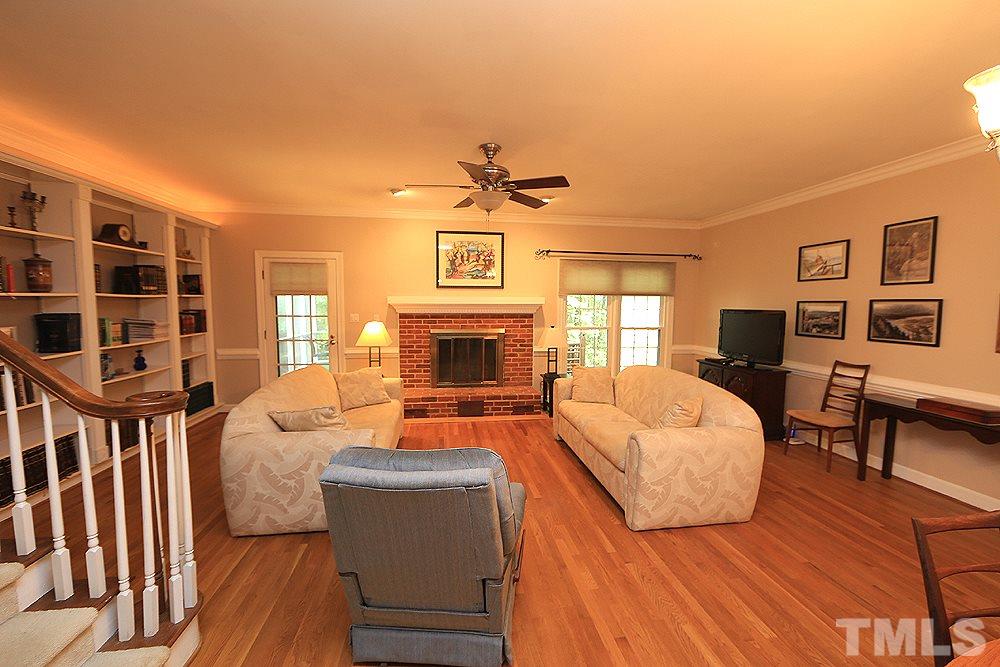 608 Weathergreen Drive Raleigh, NC 27615 - Photo 9 of 25 a living room with furniture a fireplace and a flat screen tv