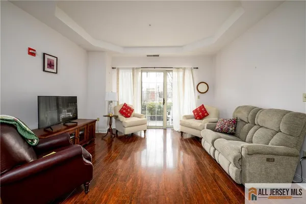 a living room with furniture window and a flat screen tv