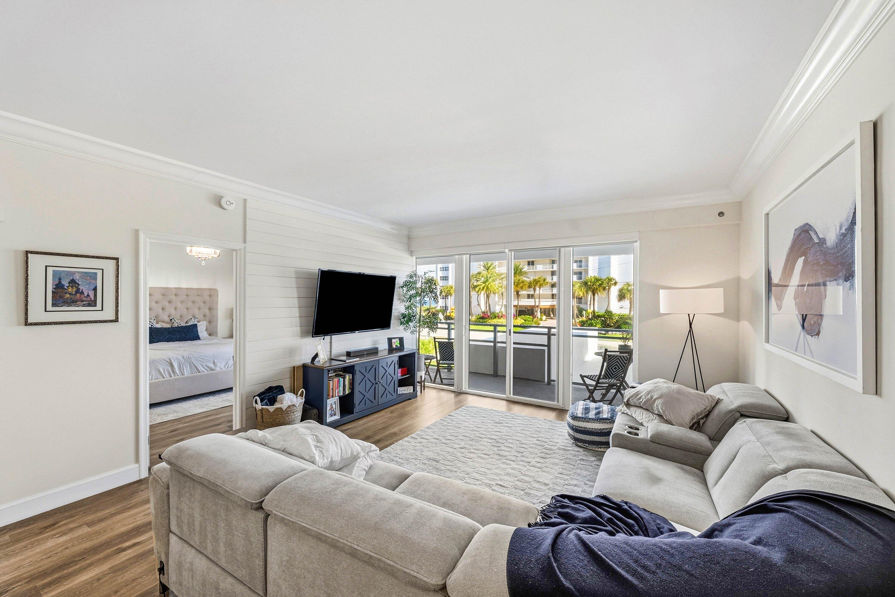 3051 South Ocean Boulevard, Unit 2050 Boca Raton, FL 33432 - Photo 11 of 32 a living room with furniture and a flat screen tv