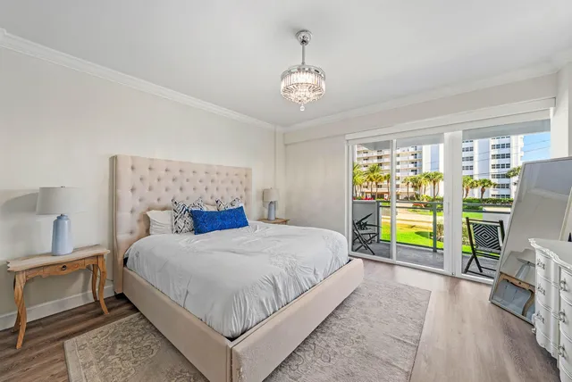a bedroom with a bed and a flat tv screen on dresser