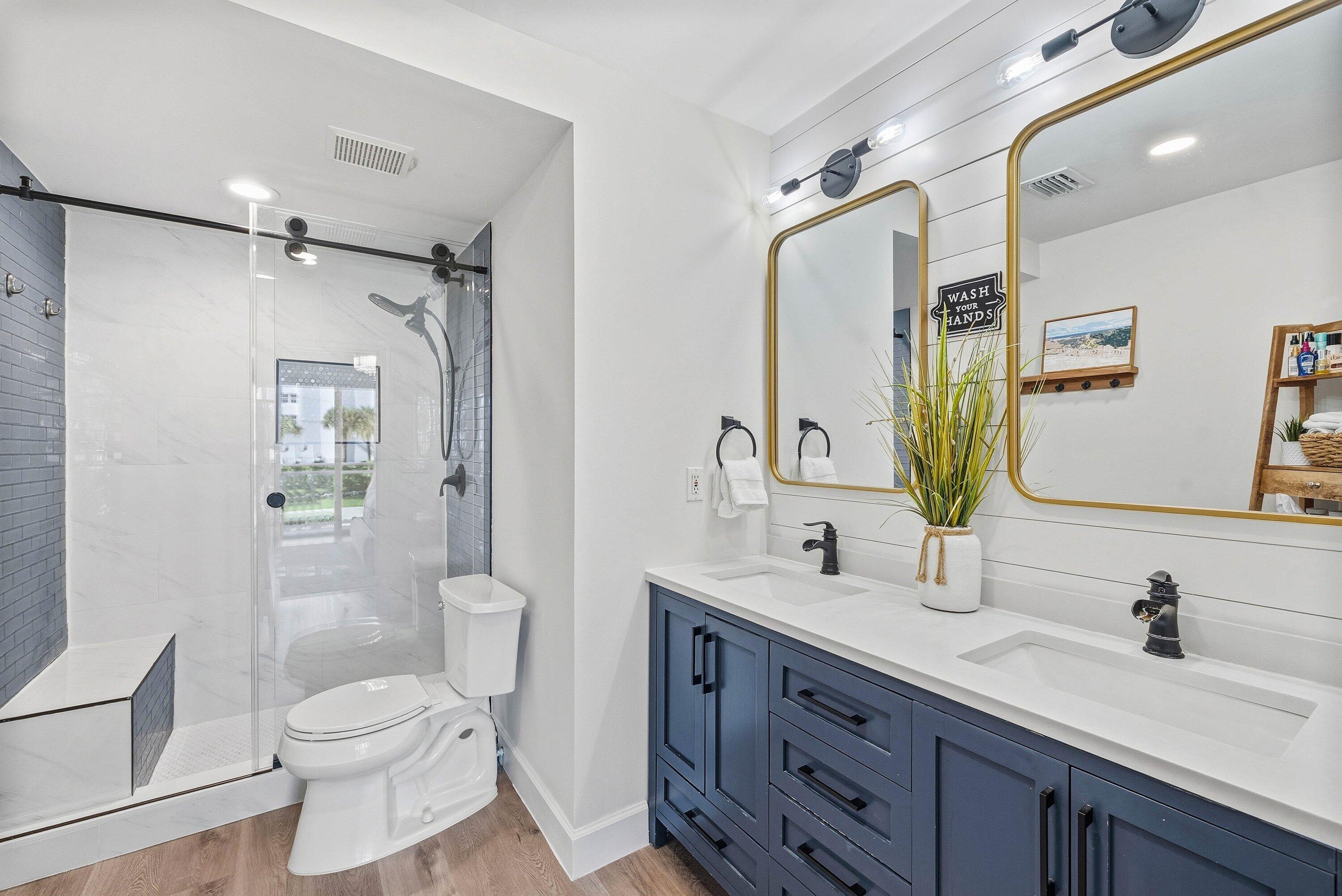 3051 South Ocean Boulevard, Unit 2050 Boca Raton, FL 33432 - Photo 17 of 32 a bathroom with a granite countertop toilet sink and a large mirror