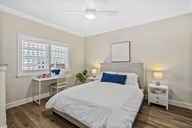 a bedroom with a large bed and a desk