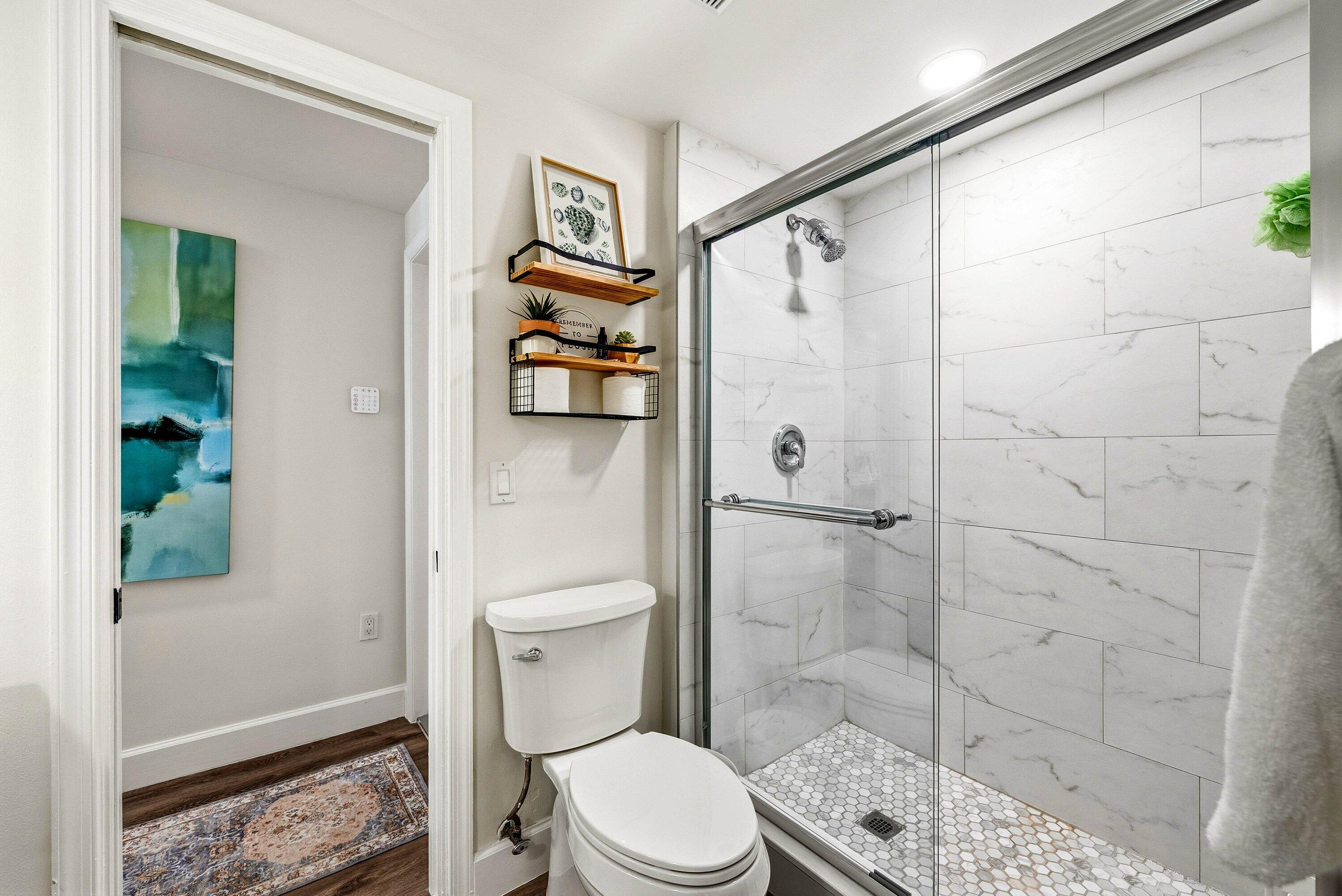 3051 South Ocean Boulevard, Unit 2050 Boca Raton, FL 33432 - Photo 22 of 32 a white toilet sitting next to a bathroom sink