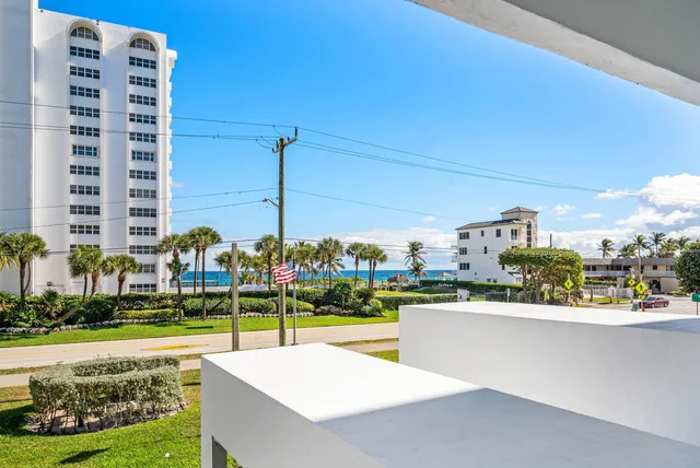a view of a house with backyard and outdoor seating