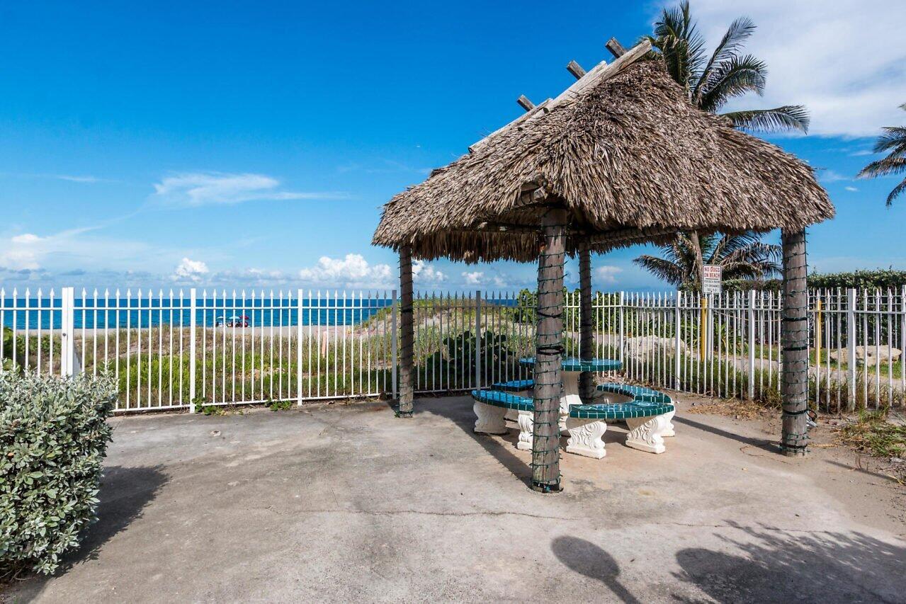 3051 South Ocean Boulevard, Unit 2050 Boca Raton, FL 33432 - Photo 27 of 32 a view of a house with backyard and outdoor seating
