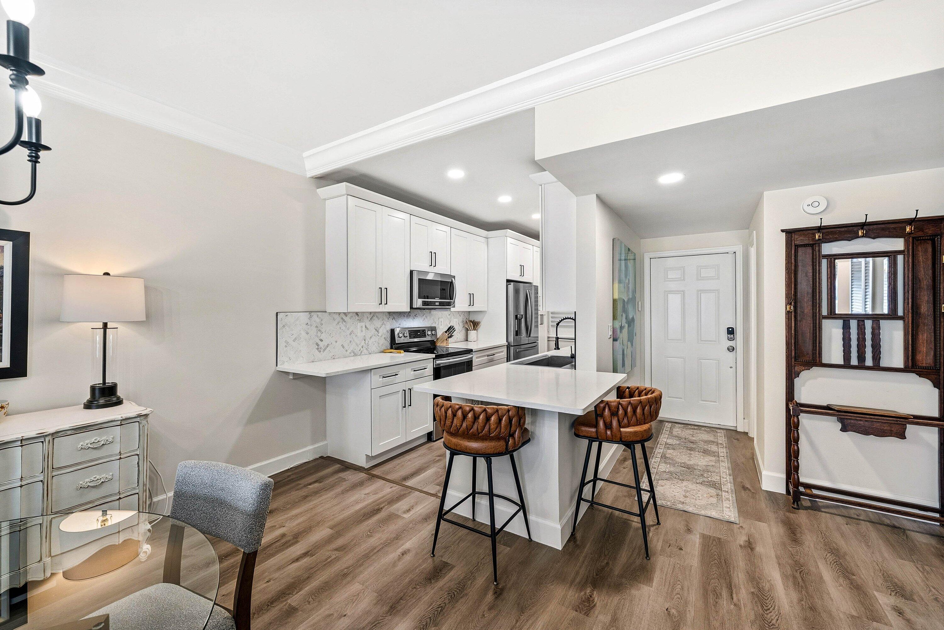 3051 South Ocean Boulevard, Unit 2050 Boca Raton, FL 33432 - Photo 4 of 32 a living room with stainless steel appliances kitchen island granite countertop furniture and wooden floor