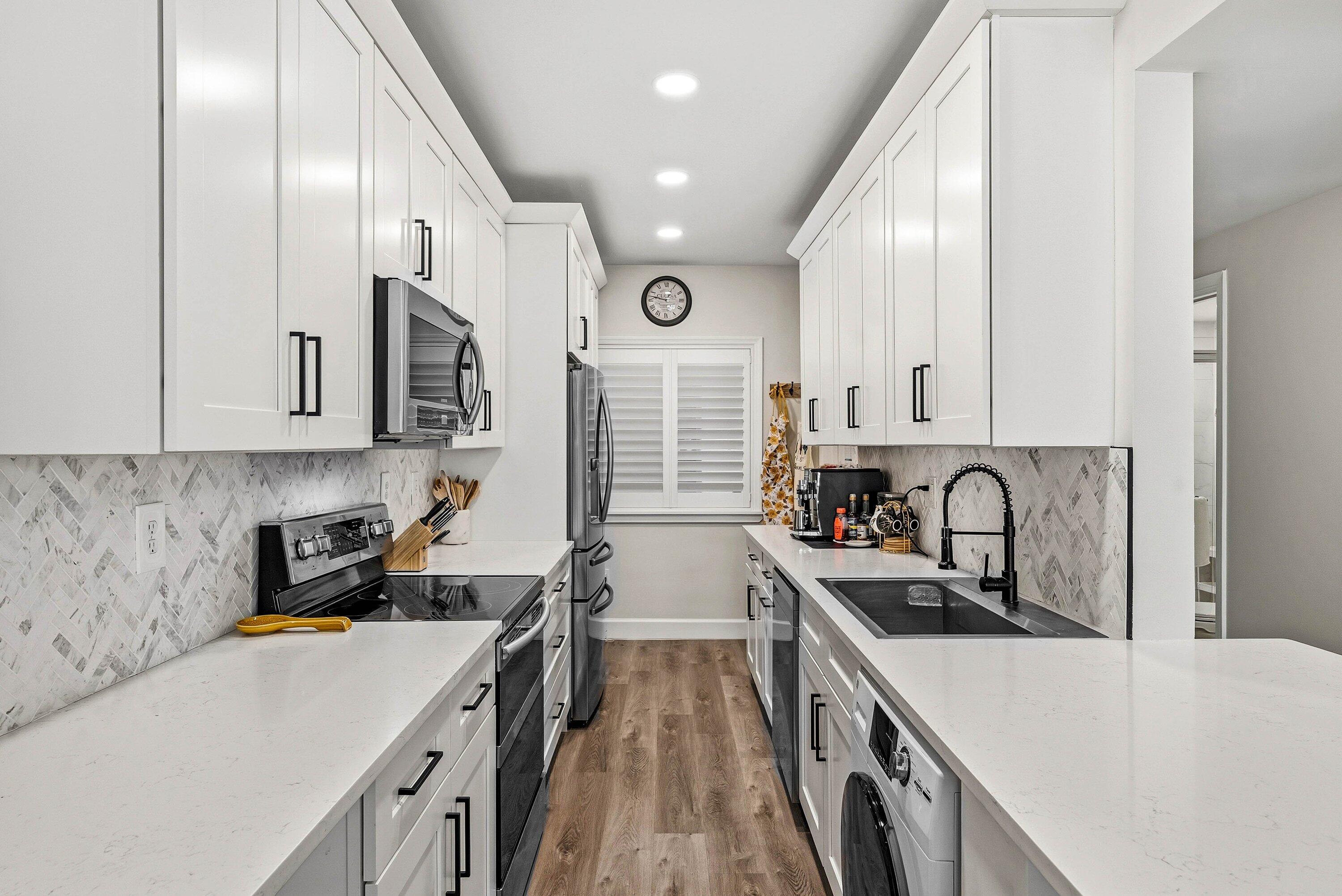 3051 South Ocean Boulevard, Unit 2050 Boca Raton, FL 33432 - Photo 6 of 32 a kitchen with stainless steel appliances granite countertop a sink stove and refrigerator