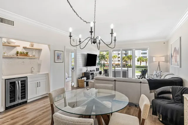 a living room with furniture a flat screen tv and a large window