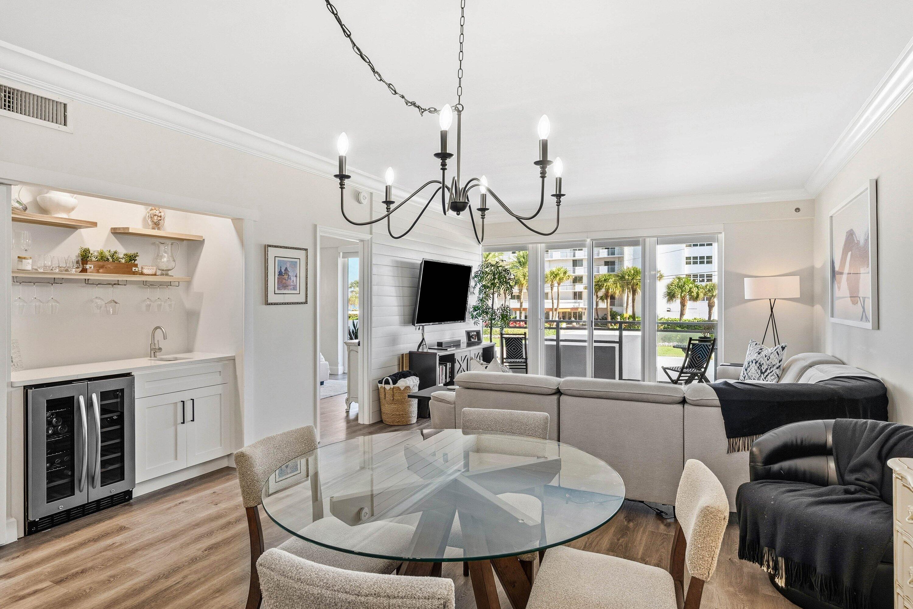 3051 South Ocean Boulevard, Unit 2050 Boca Raton, FL 33432 - Photo 9 of 32 a living room with furniture a flat screen tv and a large window