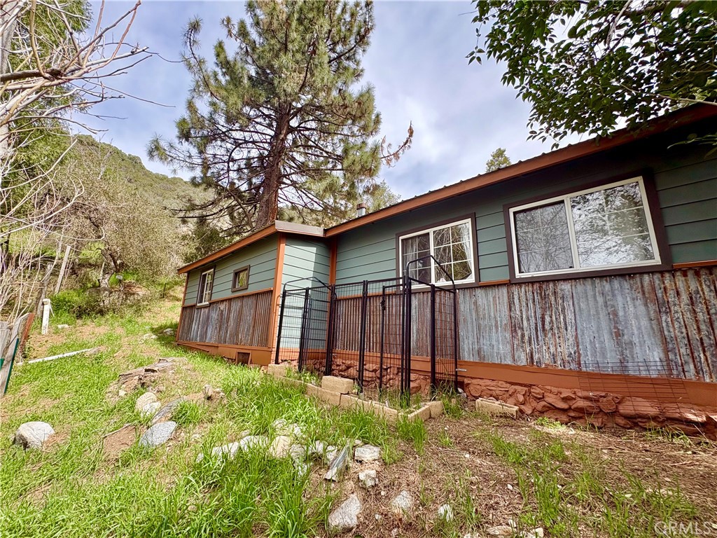 36750 Hilltop Road Yucaipa, CA 92399 - Photo 24 of 27 a view of backyard of house with wooden fence