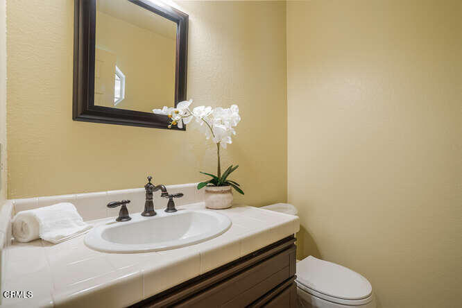 2129 Bermuda Dunes Place Oxnard, CA 93036 - Photo 23 of 42 a bathroom with a sink a toilet and mirror