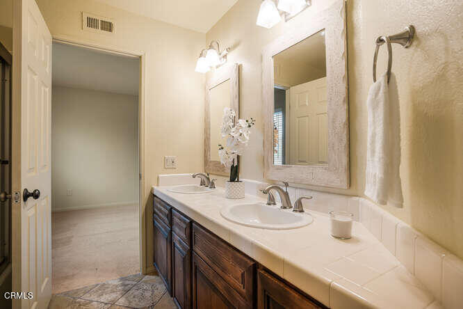 2129 Bermuda Dunes Place Oxnard, CA 93036 - Photo 29 of 42 a bathroom with a sink double vanity and a mirror