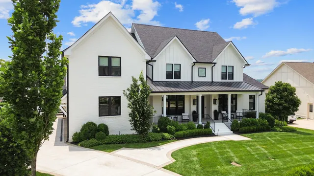 a front view of a house with a yard and porch