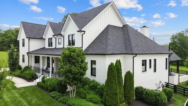a front view of a house with garden
