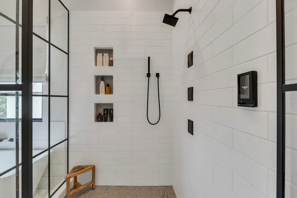 a bathroom with a shower and a mirror