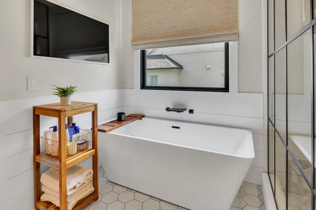 a kitchen with stainless steel appliances granite countertop a sink a stove and a wooden floors