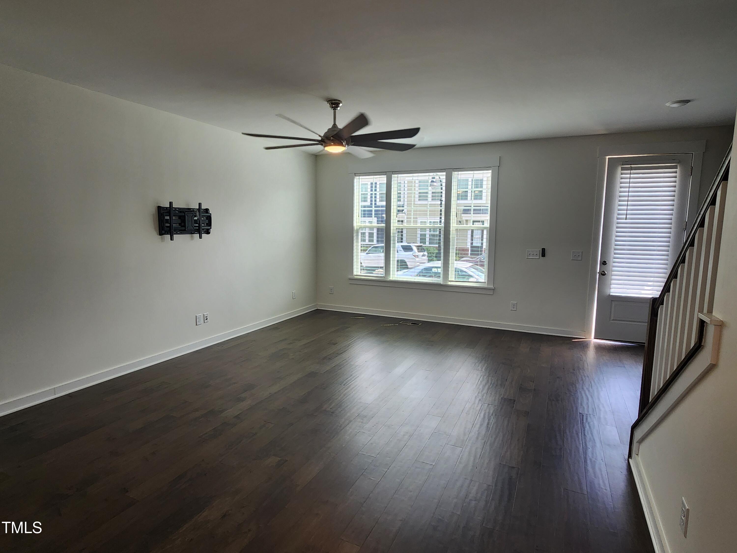 433 Rally Point Place Wake Forest, NC 27587 - Photo 2 of 15 a view of an empty room with wooden floor and a window
