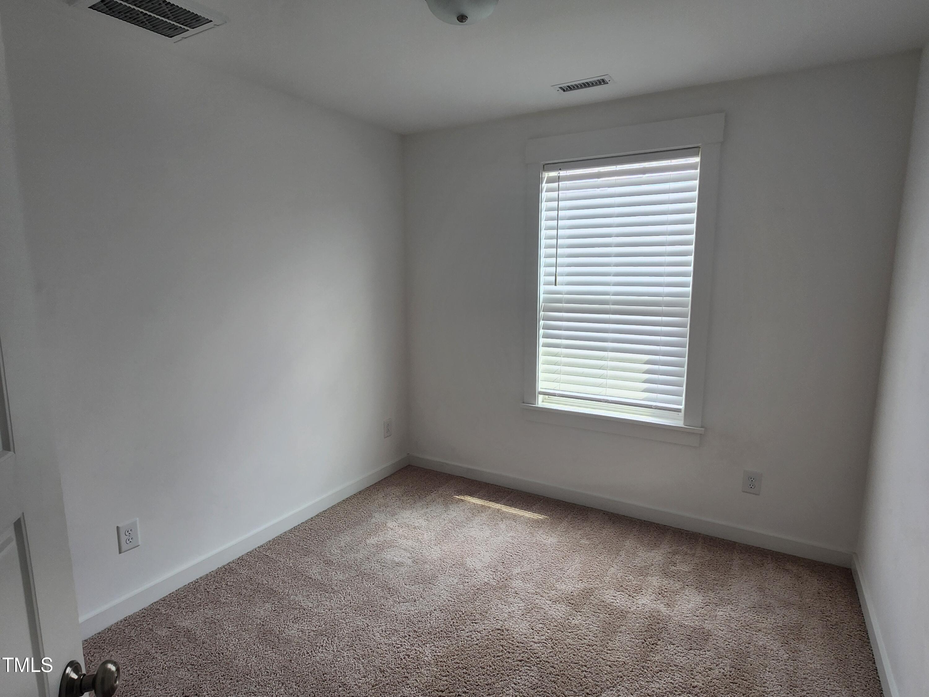 433 Rally Point Place Wake Forest, NC 27587 - Photo 9 of 15 an empty room with a window