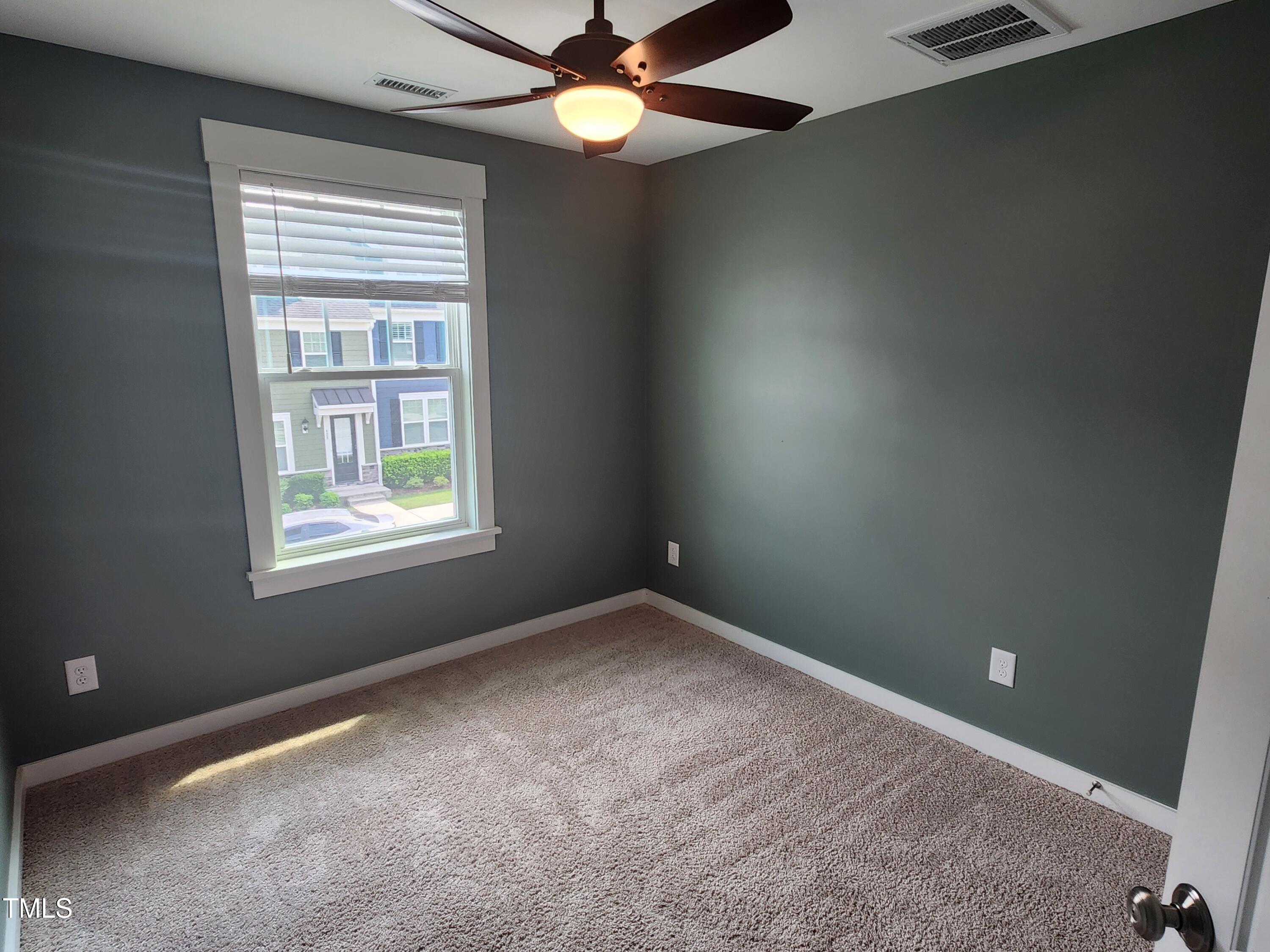 433 Rally Point Place Wake Forest, NC 27587 - Photo 10 of 15 an empty room with a window and a fan