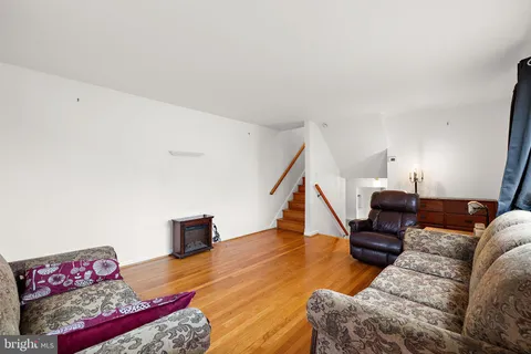 a living room with furniture and stairs