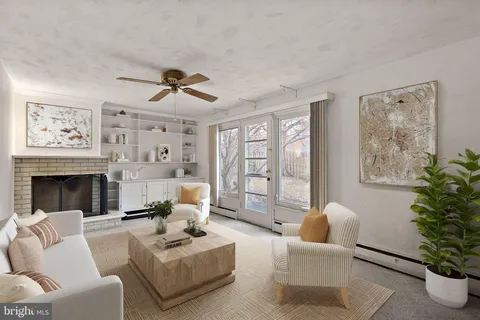 a living room with furniture potted plant and a fireplace