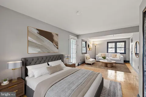 a bedroom with bed and wooden floor