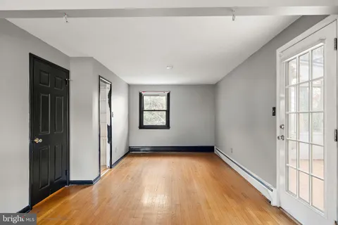 wooden floor in an empty room with a window