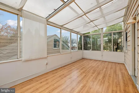 a view of room with window and wooden floor