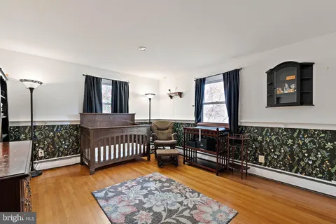a bedroom with furniture window and wooden floor