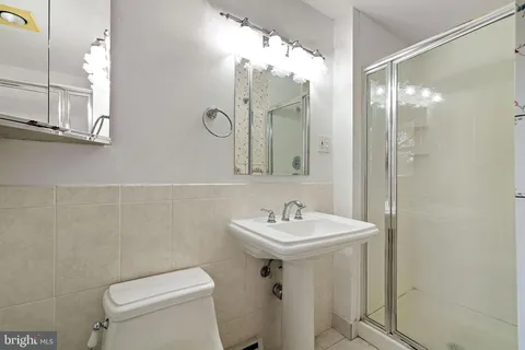 a bathroom with a sink mirror toilet and vanity