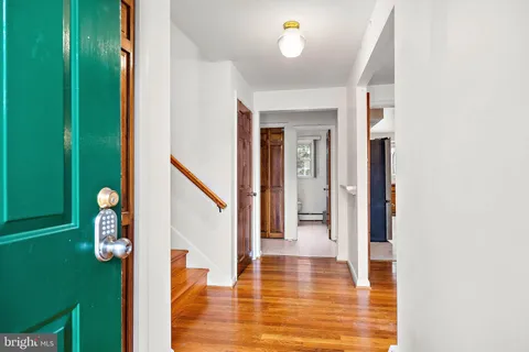 a view of entryway and hall with wooden floor