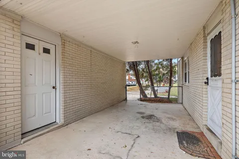 a view of a porch with hardwood floor and windows