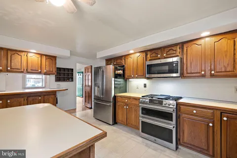 a kitchen with stainless steel appliances a stove microwave and sink