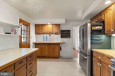 a kitchen with stainless steel appliances a refrigerator sink and microwave
