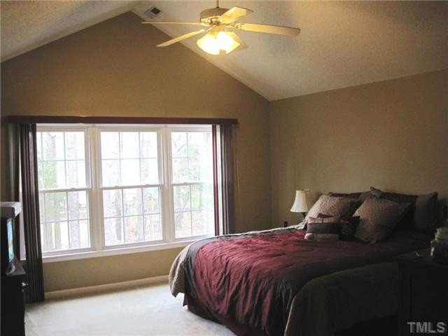 8508 Wheeling Drive Raleigh, NC 27615 - Photo 9 of 12 Large master bedroom with cathedral ceiling, ceiling fan and large master bath.