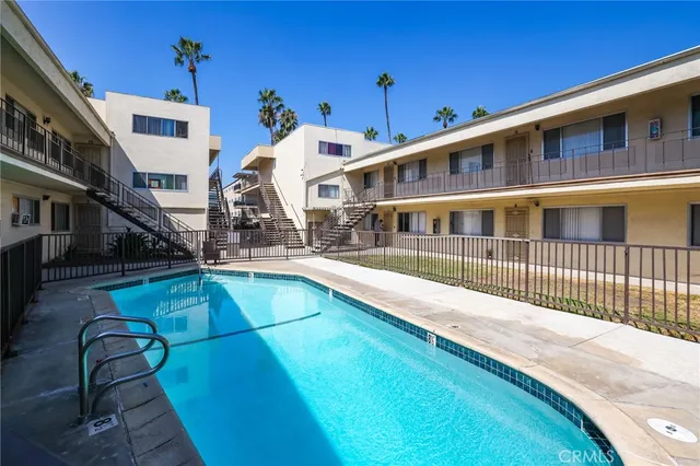 a view of a house with pool and sitting area